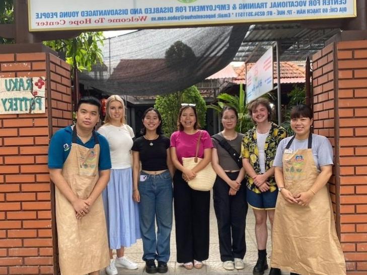 Group in front of sign for Hope Center Vietnam